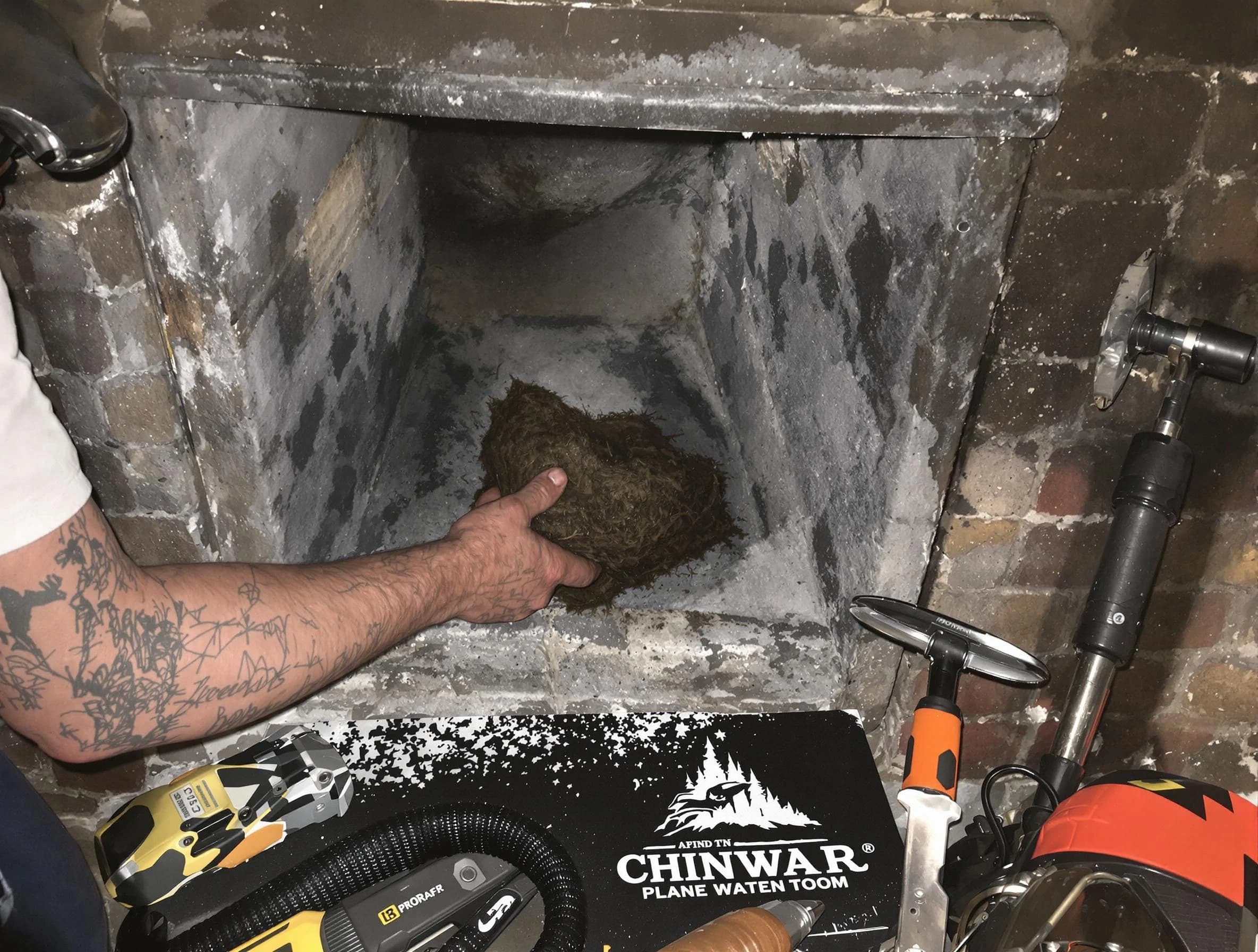 Babylon Chimney Sweep safely removing debris and screening chimney in Babylon, NY