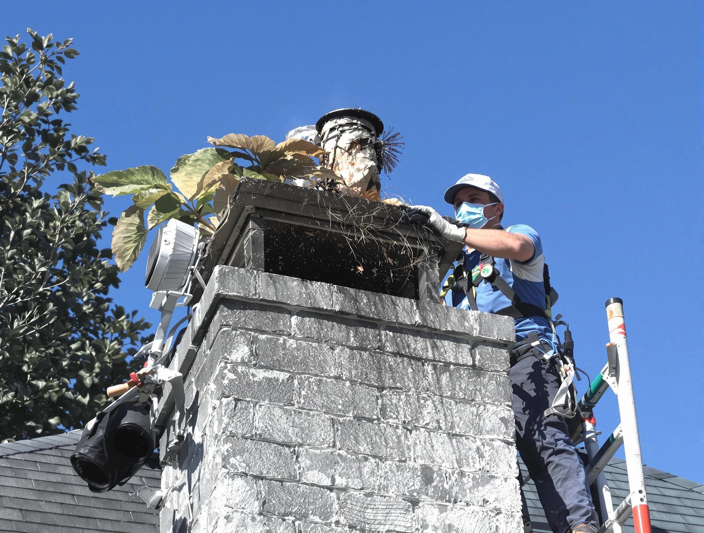 Babylon Chimney Sweep specialist performing chimney cleaning in Babylon, NY